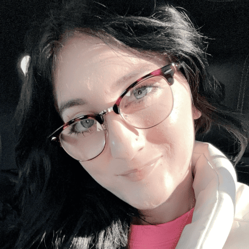 Serena wearing glasses and looking at camera